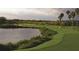 Scenic golf course with a pond and lush greenery perfect for a relaxing day of golf at 362 Fairway Isles Ln, Bradenton, FL 34212