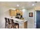 Kitchen features stainless steel appliances, bar seating, and light wood cabinets at 362 Fairway Isles Ln, Bradenton, FL 34212