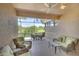 Enjoy this spacious lanai with wicker seating and views of the lush landscaping at 362 Fairway Isles Ln, Bradenton, FL 34212