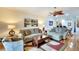 A stylish living room is furnished with modern couches, a ceiling fan, and elegant decor throughout at 362 Fairway Isles Ln, Bradenton, FL 34212
