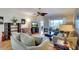 The well-lit living room showcases hardwood floors, neutral furniture, and access to an outdoor lanai at 362 Fairway Isles Ln, Bradenton, FL 34212