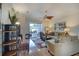 Bright living room features hardwood floors, a ceiling fan, comfortable furniture, and sliding glass doors to the lanai at 362 Fairway Isles Ln, Bradenton, FL 34212