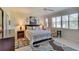 Serene main bedroom with neutral tones, plush bedding, and window with plantation shutters at 362 Fairway Isles Ln, Bradenton, FL 34212