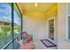 A cozy screened lanai featuring comfortable chairs, perfect for enjoying the outdoors with privacy at 362 Fairway Isles Ln, Bradenton, FL 34212