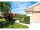 Well-manicured lawn and lush landscaping with healthy green plants surrounding the home create a serene curb appeal at 362 Fairway Isles Ln, Bradenton, FL 34212