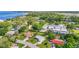 An aerial shot displaying neighborhood properties situated among mature trees near a body of water at 409 Archibald Ave, Sarasota, FL 34243