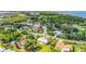 An aerial view showcases neighborhood properties nestled among mature trees at 409 Archibald Ave, Sarasota, FL 34243