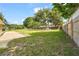 Expansive backyard featuring mature trees, a patio area, and a wooden fence, perfect for outdoor entertaining at 409 Archibald Ave, Sarasota, FL 34243