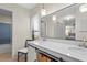 Updated bathroom features a dual sink vanity with quartz countertop and modern light fixtures at 409 Archibald Ave, Sarasota, FL 34243