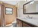 Charming bathroom featuring a walk-in shower and vanity with a quartz countertop at 409 Archibald Ave, Sarasota, FL 34243