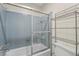 Bathroom with blue tiling around the shower and storage available at 409 Archibald Ave, Sarasota, FL 34243