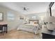 Comfortable bedroom with tile floors, neutral walls, ceiling fan and white plantation shutters at 409 Archibald Ave, Sarasota, FL 34243