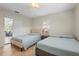 Bright bedroom features two beds, tile flooring, and natural light coming in from sliding glass doors at 409 Archibald Ave, Sarasota, FL 34243