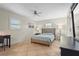 Calm bedroom featuring a queen-size bed, neutral tones, and tile floors at 409 Archibald Ave, Sarasota, FL 34243