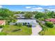 Charming single-story home with a well-manicured lawn, palm trees, and a neatly paved driveway at 409 Archibald Ave, Sarasota, FL 34243