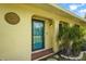 A close up of the front door featuring a bright blue door, textured walls, and decorative accents at 409 Archibald Ave, Sarasota, FL 34243