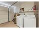 Bright garage with washer and dryer, water heater, and garage door access at 409 Archibald Ave, Sarasota, FL 34243