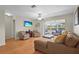 Living area with a view of the enclosed patio, multiple chairs and a large sectional sofa at 409 Archibald Ave, Sarasota, FL 34243