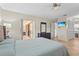 Serene main bedroom with access to the patio, TV, and ensuite bathroom at 409 Archibald Ave, Sarasota, FL 34243