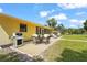 Outdoor patio with a grill, dining set, and comfortable seating, ideal for relaxing and enjoying the outdoors at 409 Archibald Ave, Sarasota, FL 34243