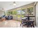 Bright sunroom with tile flooring and tons of natural light, perfect for entertaining at 409 Archibald Ave, Sarasota, FL 34243