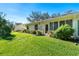 Nice view of the back of the villa highlighting a patio door and lush landscaping at 4279 Oakhurst E Cir # 3044, Sarasota, FL 34233