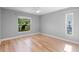 Bright bedroom featuring two windows that offer natural light and hardwood floors at 4279 Oakhurst E Cir # 3044, Sarasota, FL 34233