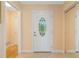 Welcoming foyer with decorative glass door, tile flooring, and a convenient mirrored closet at 4279 Oakhurst E Cir # 3044, Sarasota, FL 34233