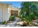Inviting front entrance with lush landscaping and a charming walkway to the villa at 4279 Oakhurst E Cir # 3044, Sarasota, FL 34233