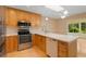 Modern kitchen with stainless steel appliances and a breakfast bar area at 4279 Oakhurst E Cir # 3044, Sarasota, FL 34233