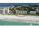 Stunning aerial view of the beachfront condo highlighting ocean access, community pools, and lush landscaping at 4325 Gulf Of Mexico Dr # 204, Longboat Key, FL 34228