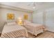 Well lit bedroom featuring two beds, wooden floors, closet and bright white walls with accent paintings at 4325 Gulf Of Mexico Dr # 204, Longboat Key, FL 34228