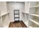 Walk-in closet featuring shelving, racks, and a wooden floor at 4325 Gulf Of Mexico Dr # 204, Longboat Key, FL 34228