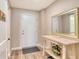 Welcoming entryway featuring a console table, mirror, and a charming floral arrangement at 4325 Gulf Of Mexico Dr # 204, Longboat Key, FL 34228