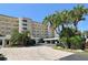 View of building's exterior elevation featuring a beautiful, well-maintained landscape and driveway at 4325 Gulf Of Mexico Dr # 204, Longboat Key, FL 34228