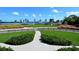 Beautifully maintained green space with a walkway, picnic shelter, and water views under a clear blue sky with some clouds at 4325 Gulf Of Mexico Dr # 204, Longboat Key, FL 34228