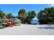 Various kayaks and boards are neatly racked near a sandy beach and dock overlooking the calm water at 4325 Gulf Of Mexico Dr # 204, Longboat Key, FL 34228
