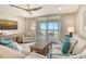 Bright living room with balcony access and views, a comfortable couch, and beachy decor at 4325 Gulf Of Mexico Dr # 204, Longboat Key, FL 34228