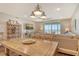 Bright living room with a ceiling fan, natural wood table, and a comfortable couch at 4325 Gulf Of Mexico Dr # 204, Longboat Key, FL 34228