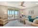 Bright living room featuring a ceiling fan, comfortable seating, and a sliding glass door to an outdoor balcony at 4325 Gulf Of Mexico Dr # 204, Longboat Key, FL 34228