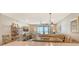 Living room with furniture, a ceiling fan, and a sliding glass door leading to a balcony with an ocean view at 4325 Gulf Of Mexico Dr # 204, Longboat Key, FL 34228
