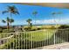 Expansive ocean views from the balcony with palm trees, sandy beaches and lush landscaping at 4325 Gulf Of Mexico Dr # 204, Longboat Key, FL 34228