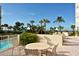 Enjoy the outdoor patio seating with table and view of palm trees, landscaping, and the ocean at 4325 Gulf Of Mexico Dr # 204, Longboat Key, FL 34228