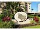 Tiffany Plaza signage surrounded by lush greenery, beautiful landscaping, and well-maintained grounds at 4325 Gulf Of Mexico Dr # 204, Longboat Key, FL 34228
