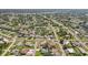 Overhead neighborhood view of a residential area with tree coverage and numerous single Gathering homes at 4330 Alligator Dr, Venice, FL 34293
