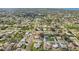 Aerial neighborhood view showcasing tree-lined streets, sidewalks, and well-maintained properties at 4330 Alligator Dr, Venice, FL 34293