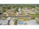 Aerial view of the property featuring a pool, lush landscaping, and neighborhood at 4330 Alligator Dr, Venice, FL 34293