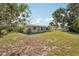 Back exterior showcasing screened lanai and serene surroundings at 4330 Alligator Dr, Venice, FL 34293