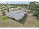 Back aerial showcasing screened lanai and ample yard space at 4330 Alligator Dr, Venice, FL 34293