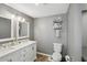 Bathroom featuring double sinks, updated vanity, and a modern toilet at 4330 Alligator Dr, Venice, FL 34293